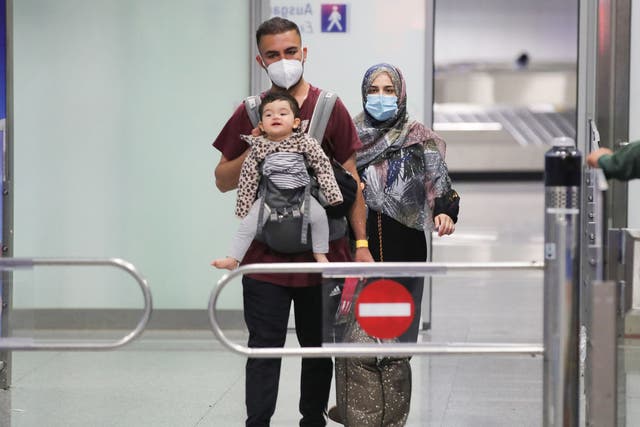<p>A young family who are among the first evacuees to arrive from Kabul at Frankfurt International Airport on Saturday </p>