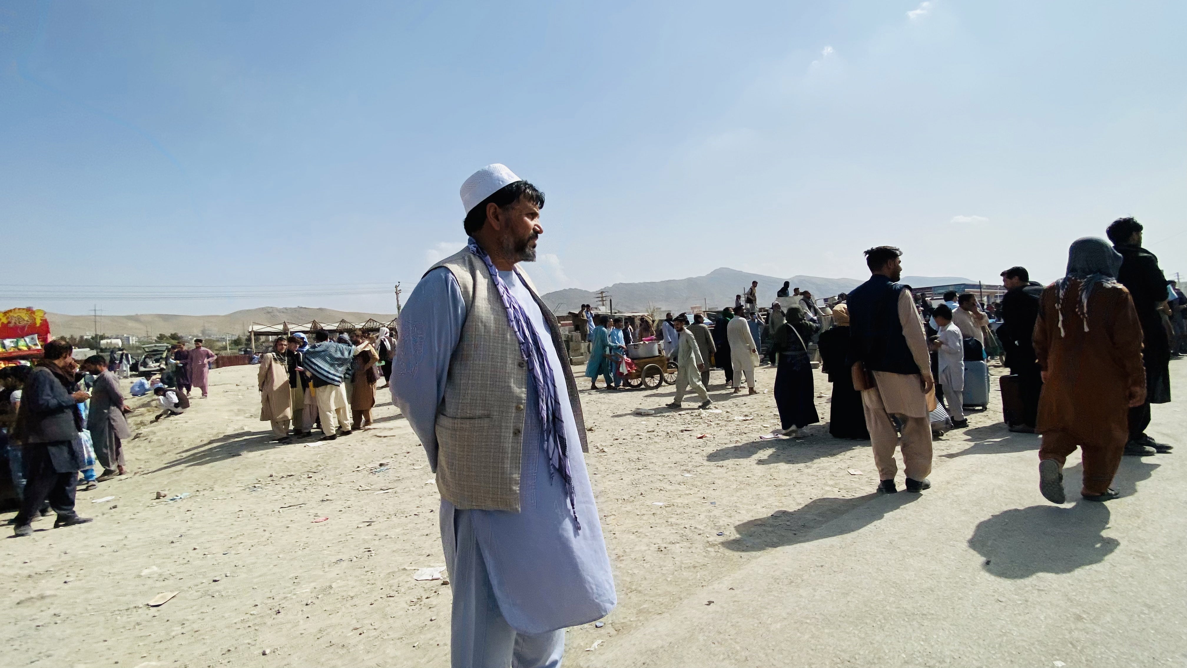 Afghans gather outside the Hamid Karzai International Airport to flee the country, in Kabul, Afghanistan, 19 August 2021