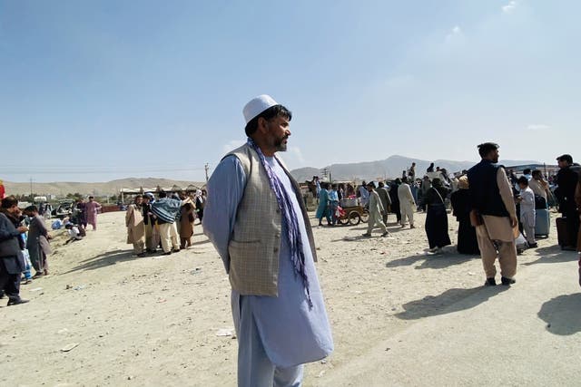 <p>Afghans gather outside the Hamid Karzai International Airport to flee the country, in Kabul, Afghanistan, 19 August 2021</p>