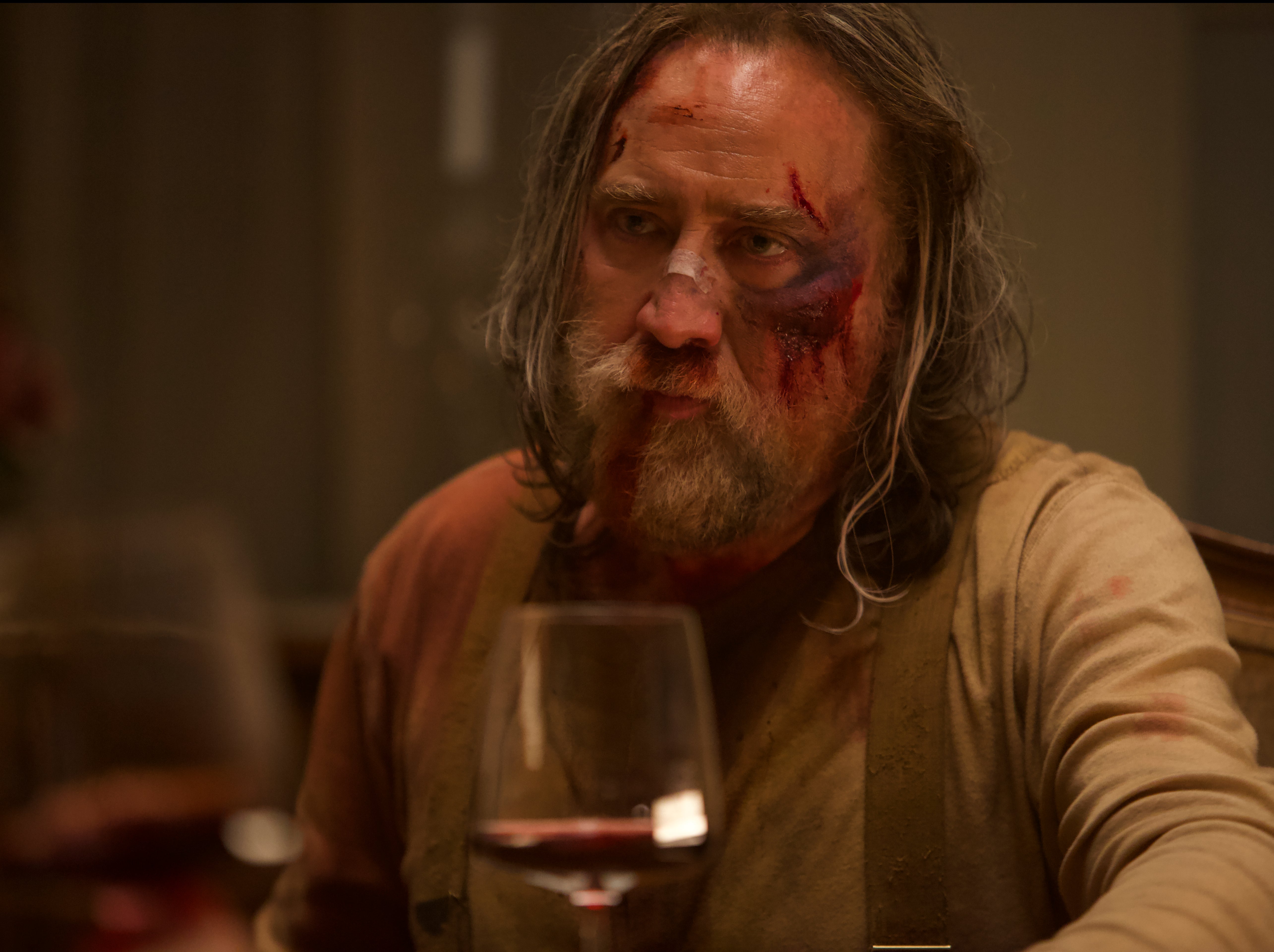 Nicolas Cage’s Rob is half-hidden behind his mountain-man beard, straggly hair, clotted blood, and dishevelled clothes