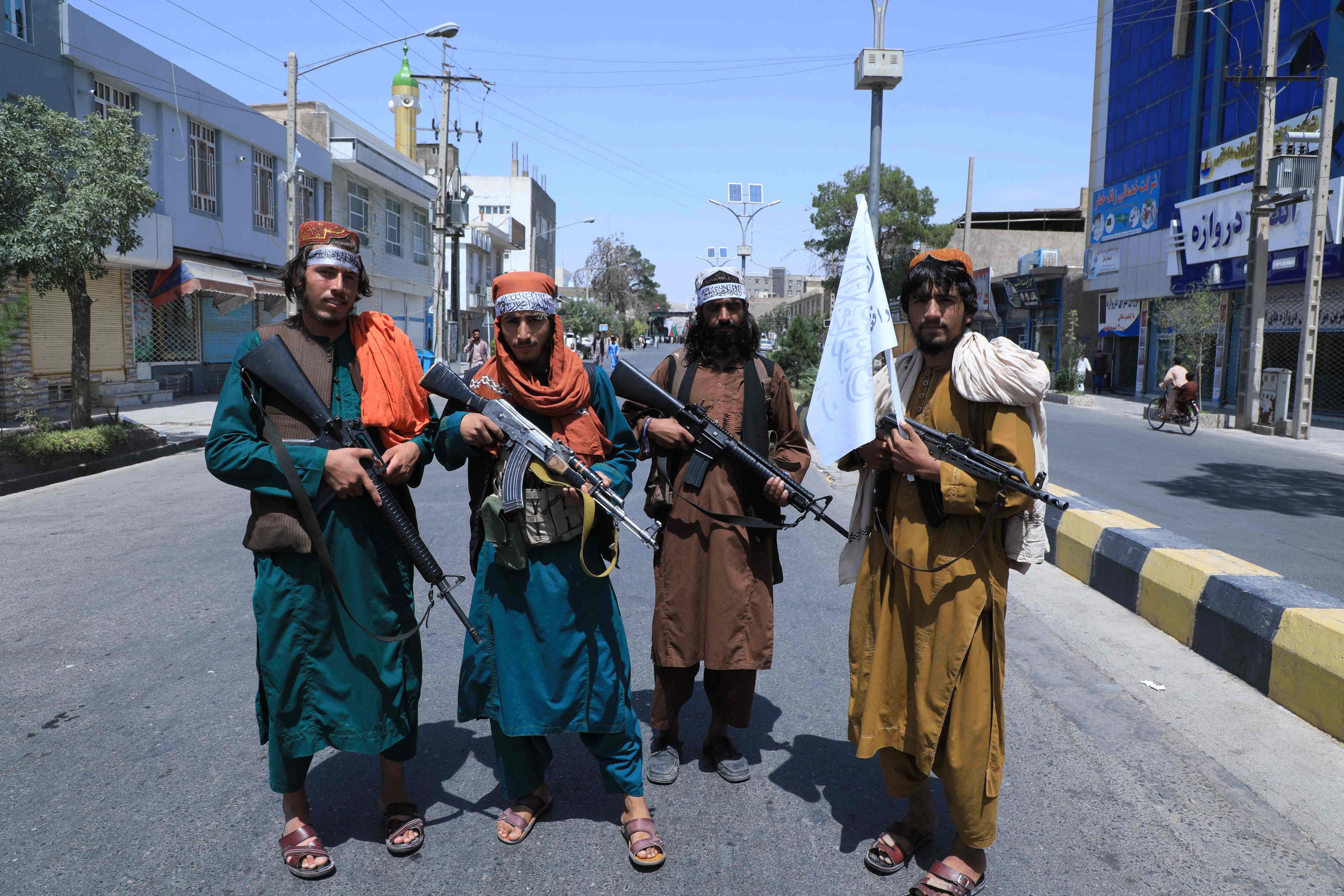 Taliban fighters stand guard in Herat