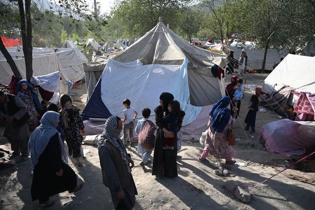 <p>Displaced Afghan families in temporary shelter after fleeing local fighting</p>