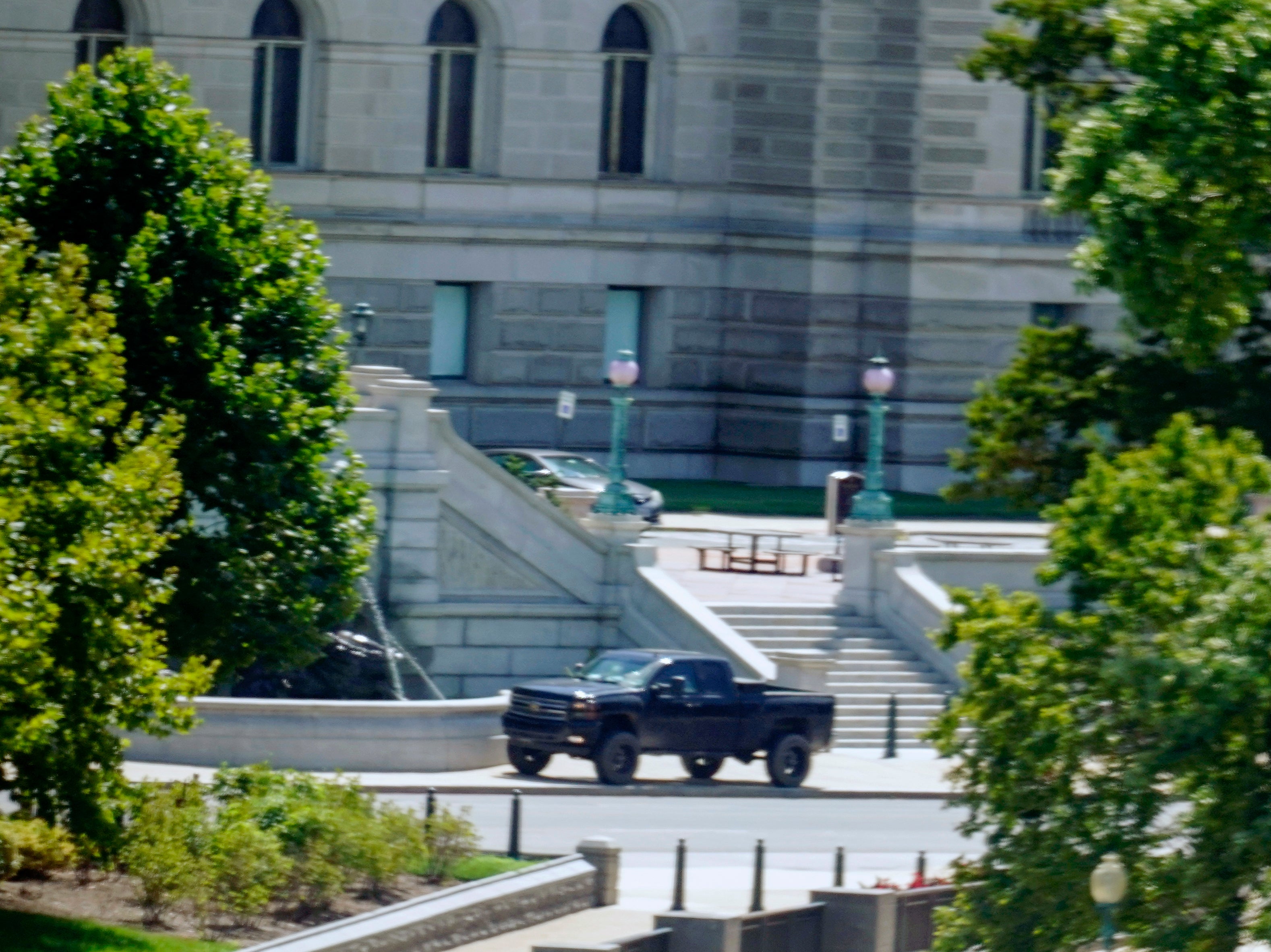 A pickup truck is parked on the sidewalk in front of the Library of Congress' Thomas Jefferson Building, as seen from a window of the U.S. Capitol, Thursday, Aug. 19, 2021, in Washington.