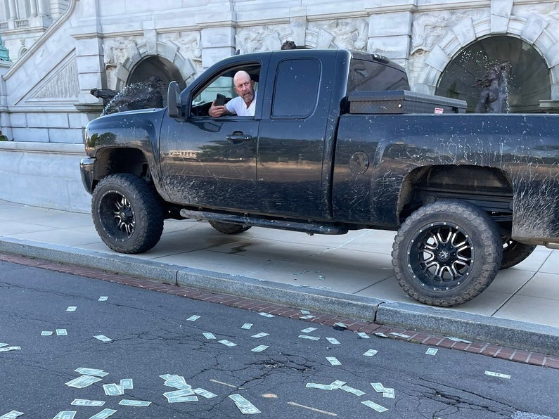 An eyewitness photo from near the Library of Congress shows the alleged suspect threatening the Capitol area with potential explosives.
