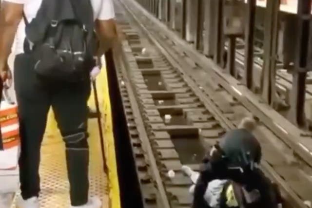 <p>An NYPD officer on subway tracks in the Bronx assisting a man who passed out and fell into the path of an oncoming subway train. The man was rescued thanks to the police officer and a Good Samaritan. </p>