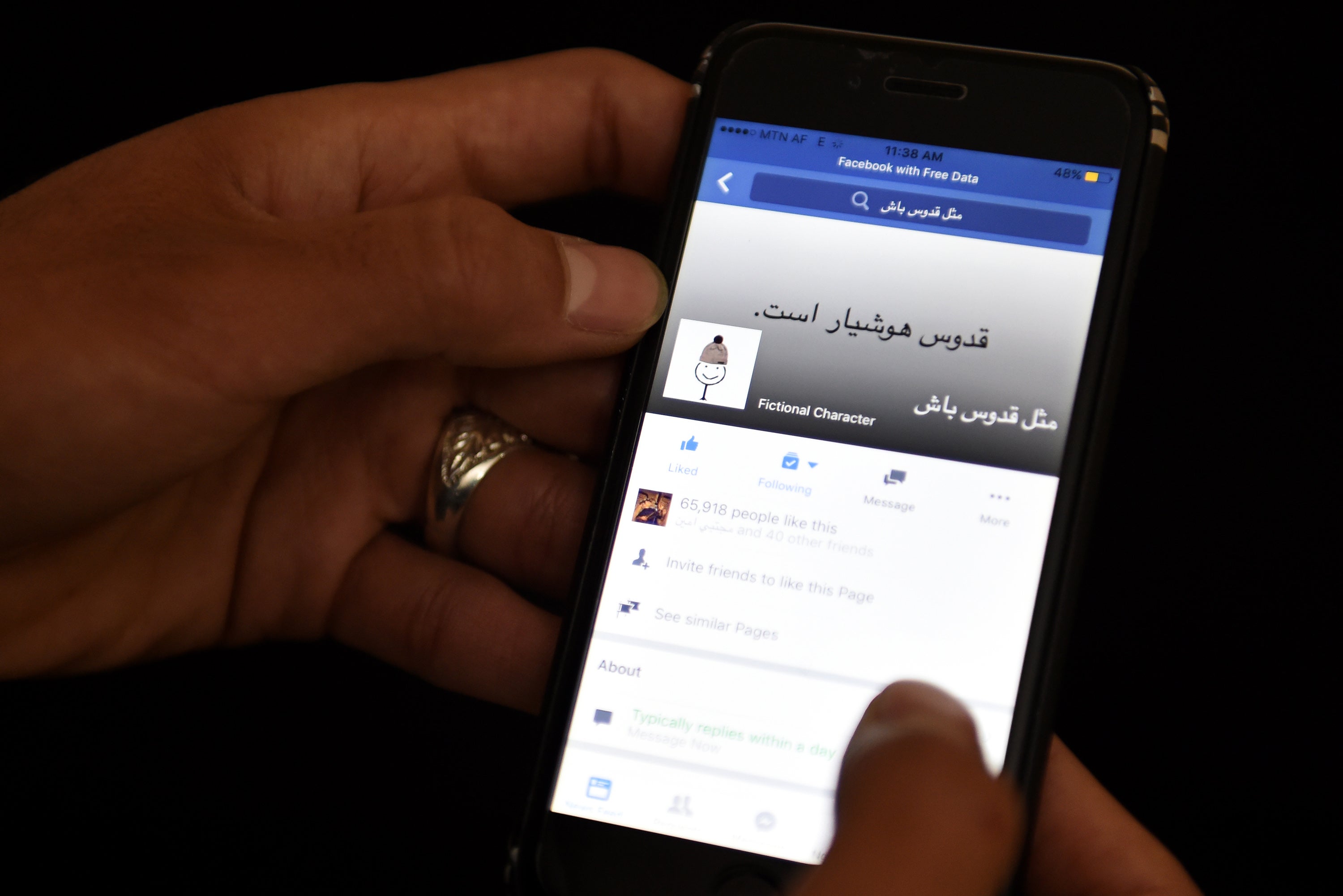 An Afghan university student looks at a meme on a Facebook account in Kabul on January 30 2016