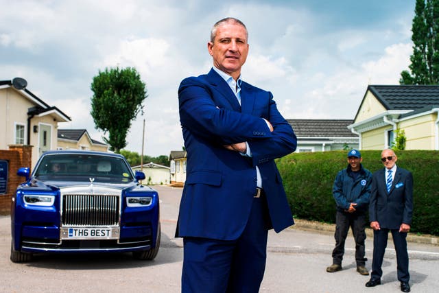 <p>Self-made millionaire Alfie Best at Wyldecrest Parks in Essex with his Rolls-Royce and park workers   </p>
