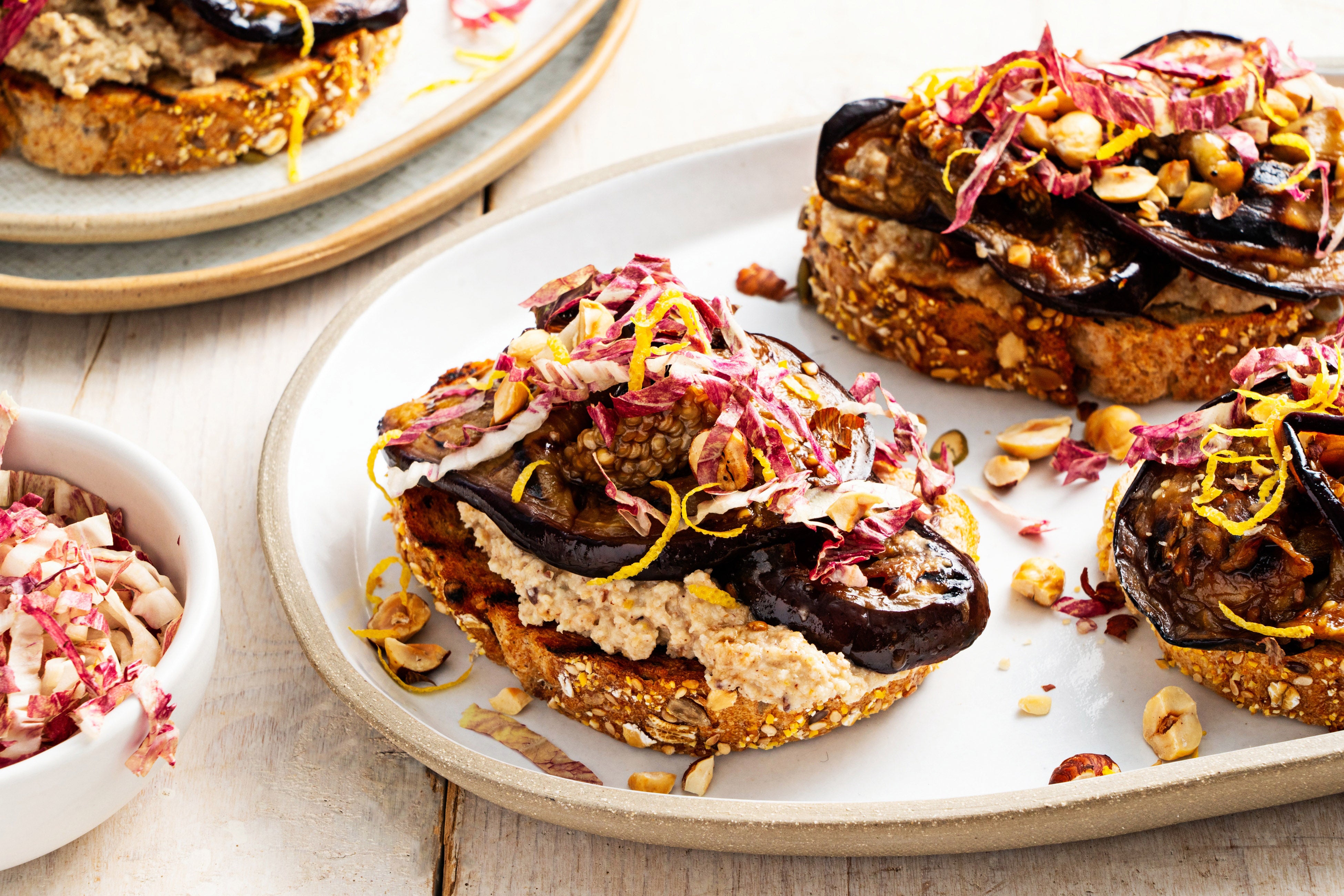 Skordalia, a garlicky Greek spread of nuts, bread and potatoes, anchors these hearty toasts
