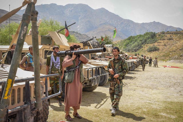 <p>Armed Afghans supporting security forces against the Taliban stand next to their Humvees at Parakh area in Bazarak, Panjshir province on Thursday </p>