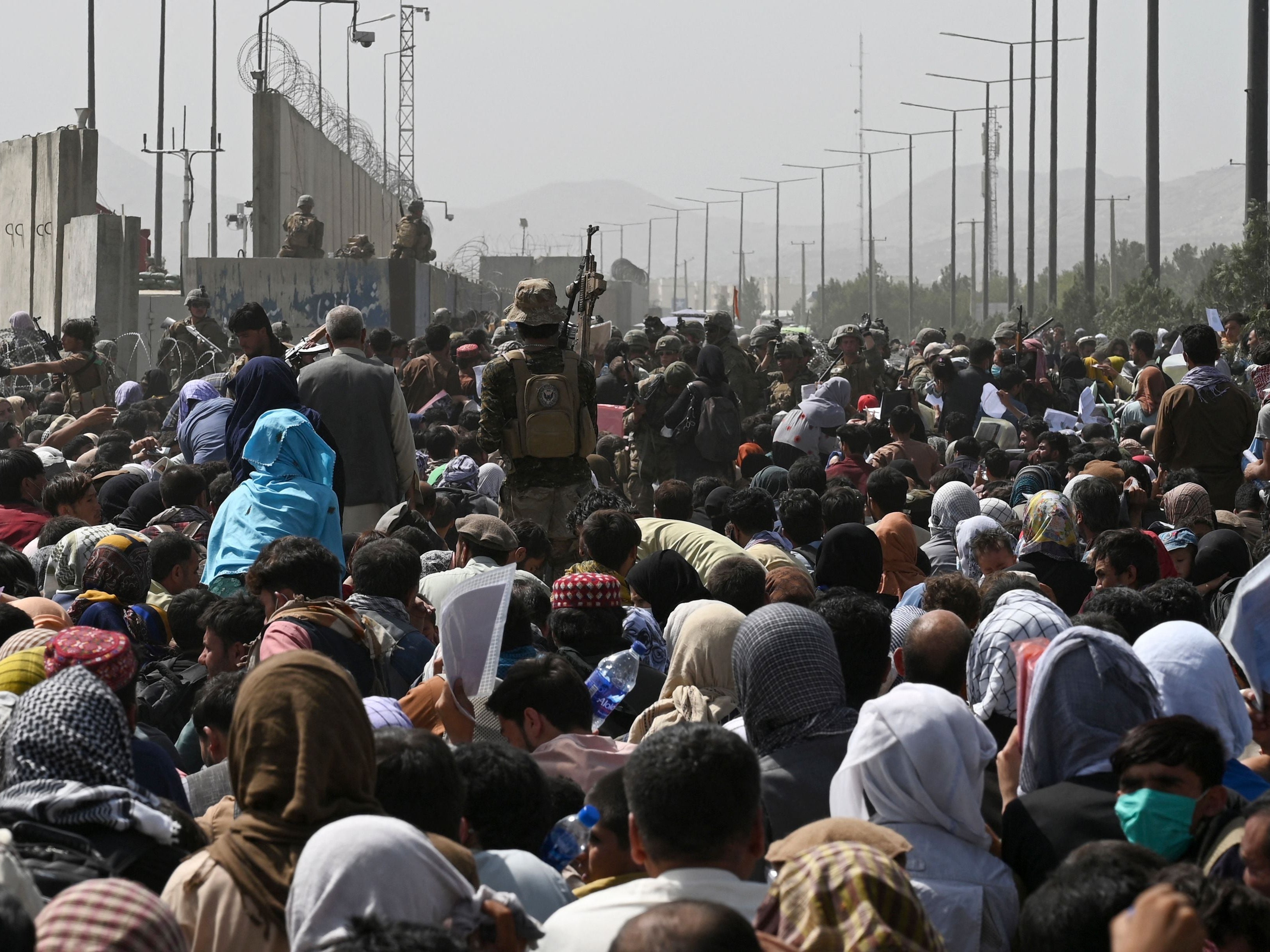 Afghans gather near the airport in Kabul, hoping to flee the country