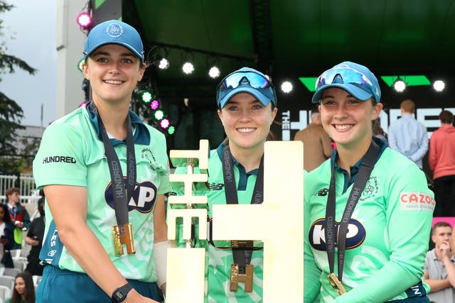 Oval Invincibles’ Grace Gibbs, Mady Villiers and Alice Capsey (left-right) lift the inaugural Hundred trophy after the women’s final of The Hundred at Lord’s (Steven Paston/PA Images).