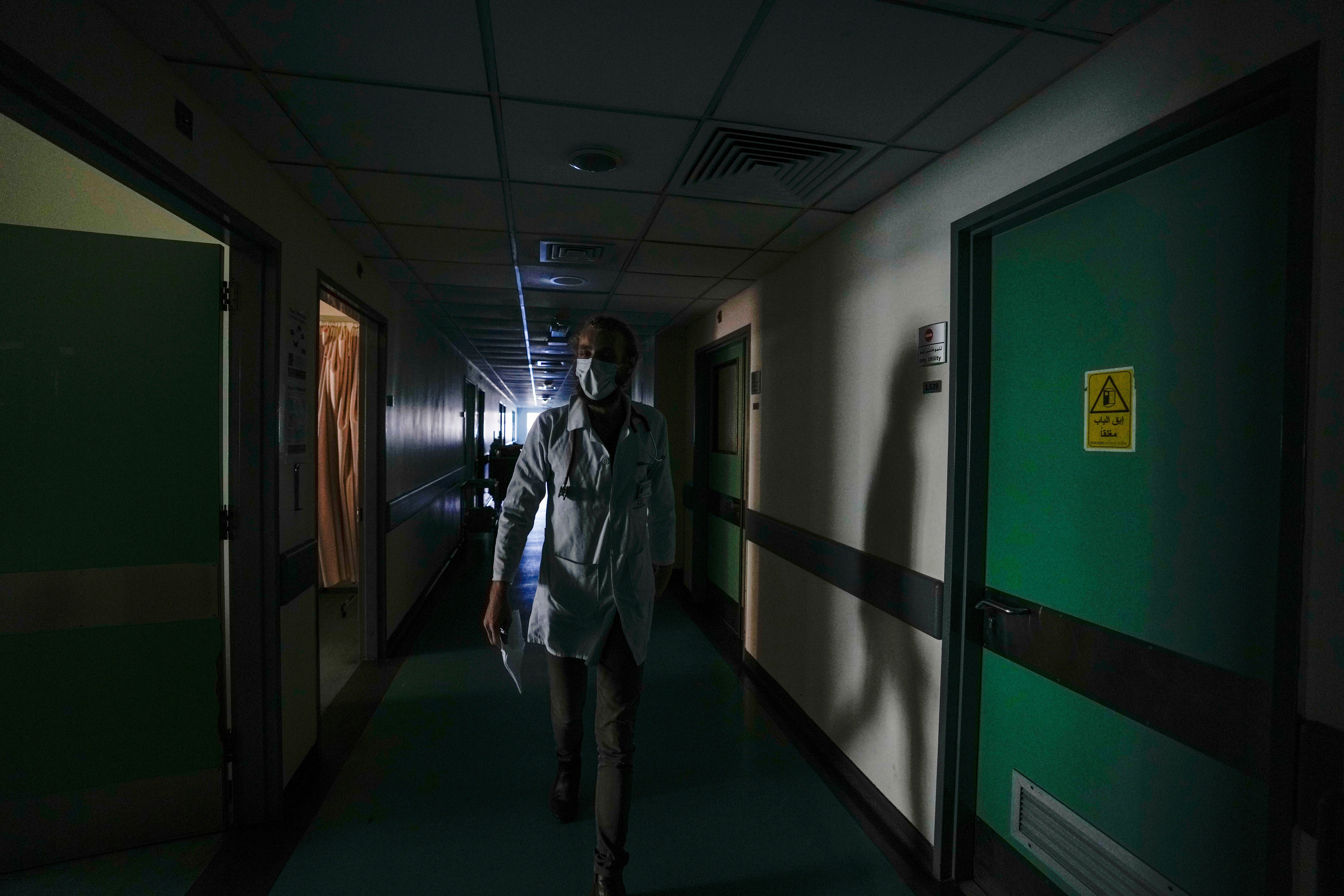 A doctor walks through a corridor of the government-run Rafik Hariri University Hospital during a power outage in Beirut this month