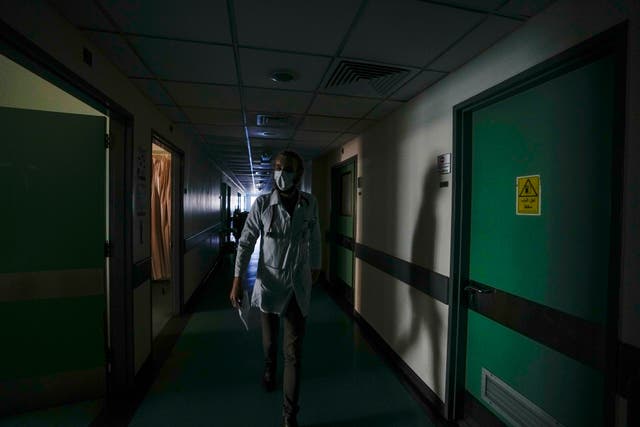 <p>A doctor walks through a corridor of the government-run Rafik Hariri University Hospital during a power outage in Beirut this month </p>