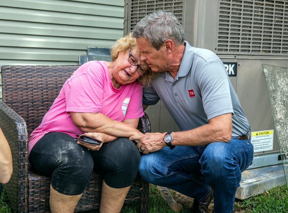 pState governor Bill Lee comforts Shirley Foster, who had just learned a friend of hers had died in the flooding in Waverly, Tennessee, on Sunday 22 August 2021/p