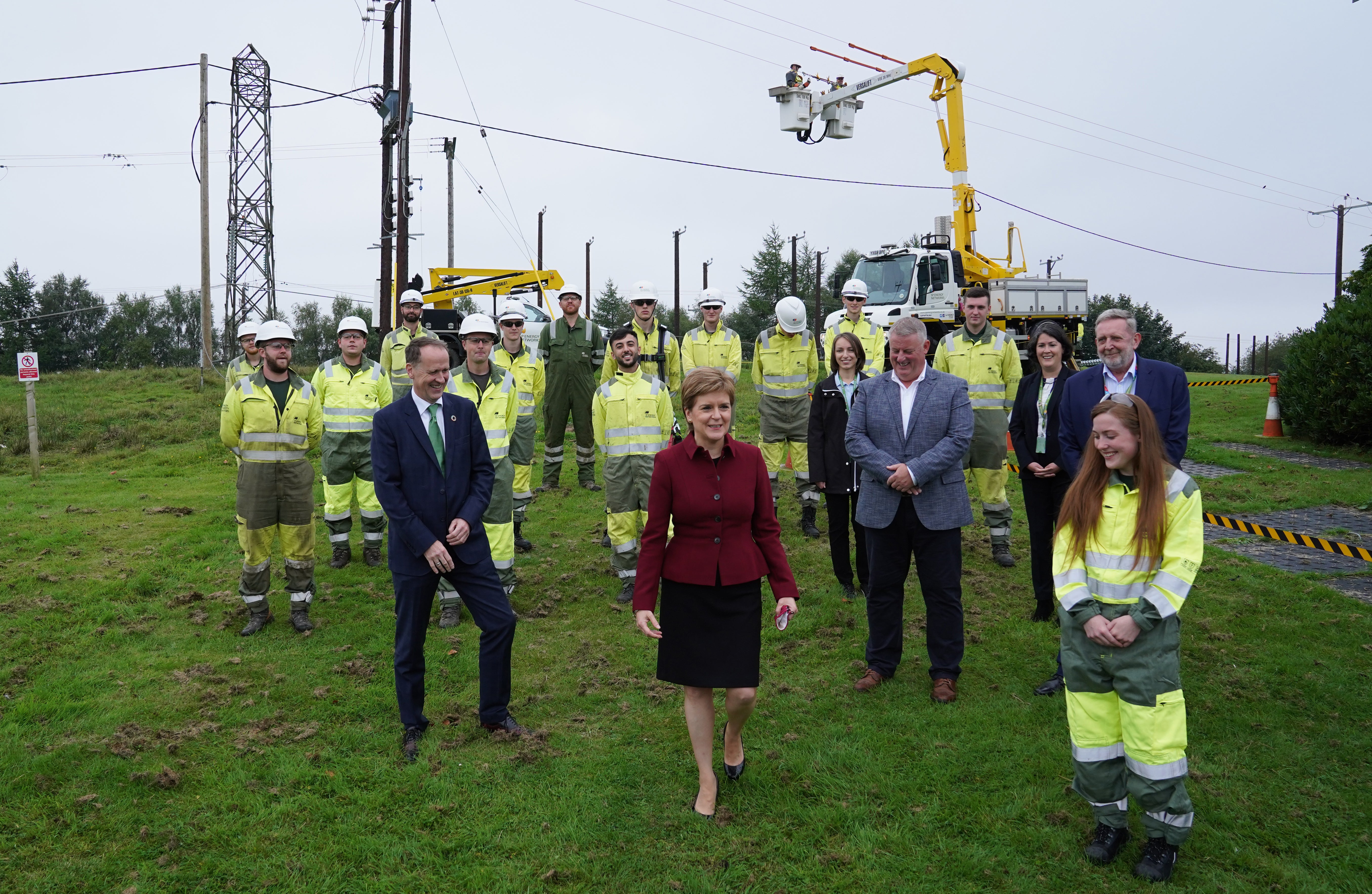 First Minister Nicola Stugeon, with Scottish Power chief executive Keith Anderson (left) and some of the company’s apprentice engineers (Andrew Milligan/PA)