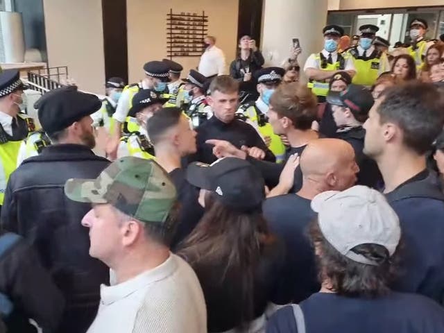 <p>Demonstrators inside the ITN building on Gray’s Inn Road, while police officers line the entrance</p>