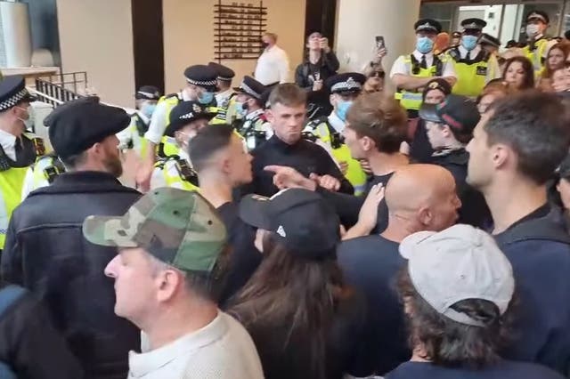 <p>Demonstrators inside the ITN building on Gray’s Inn Road, while police officers line the entrance</p>