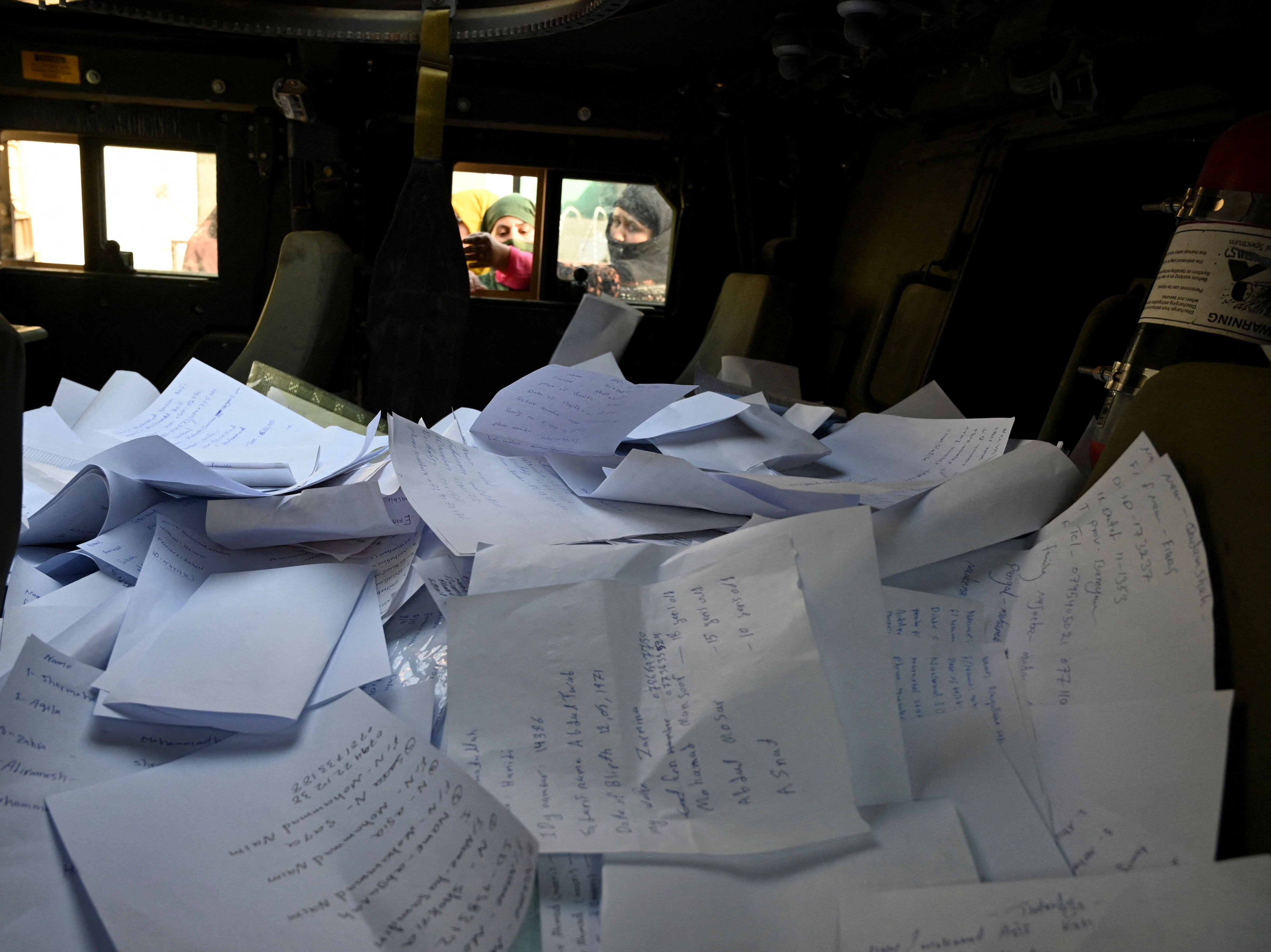 Stack of sheets filled with details of Afghan residents wishing to leave the country is pictured inside a Humvee in front of the British and Canadian embassies