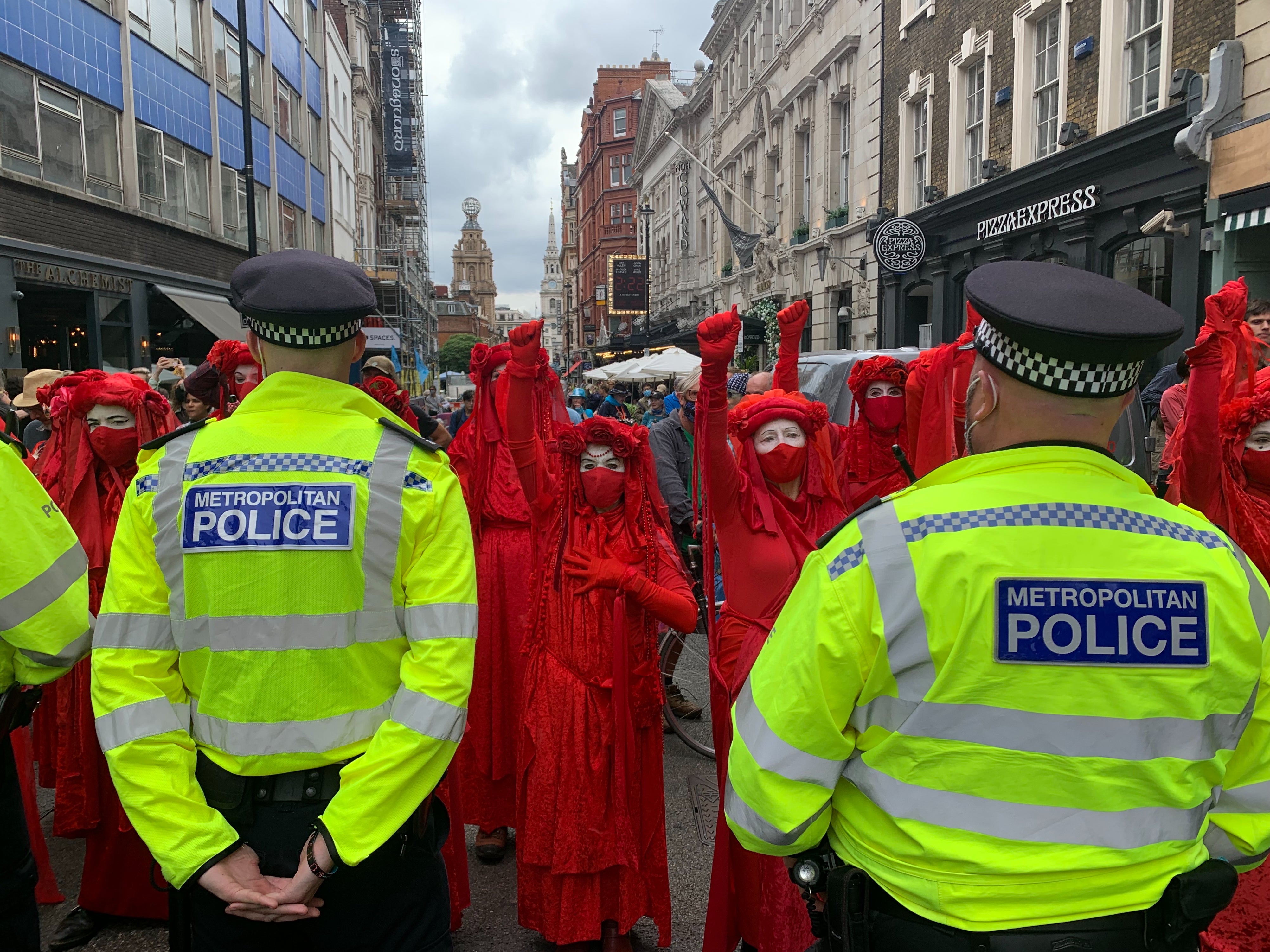 XR’s infamous red-robed protesters stand in front of one of the six human barriers formed by Met Police officers