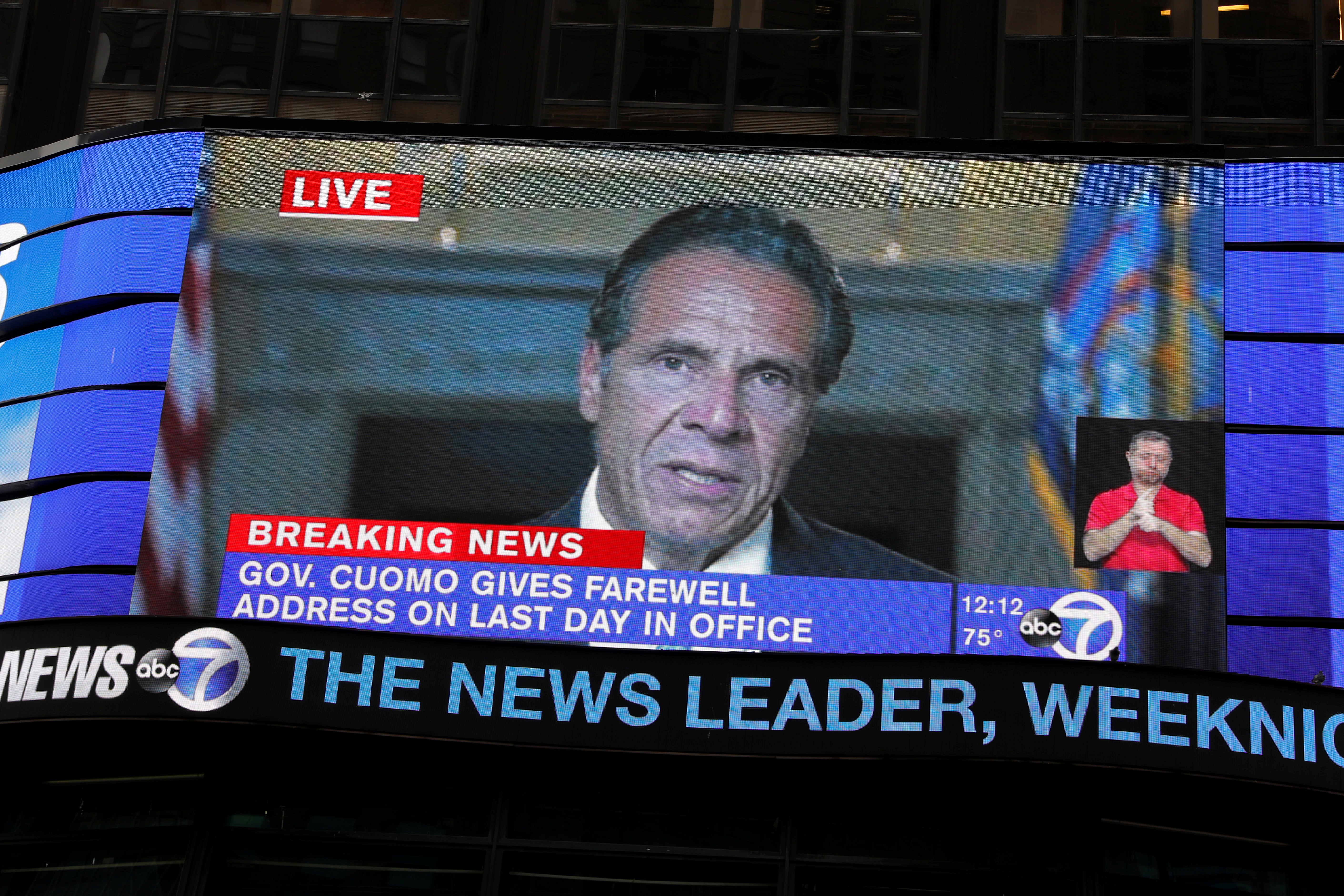 A screen in New York’s Times Square shows Andrew Cuomo’s farewell speech