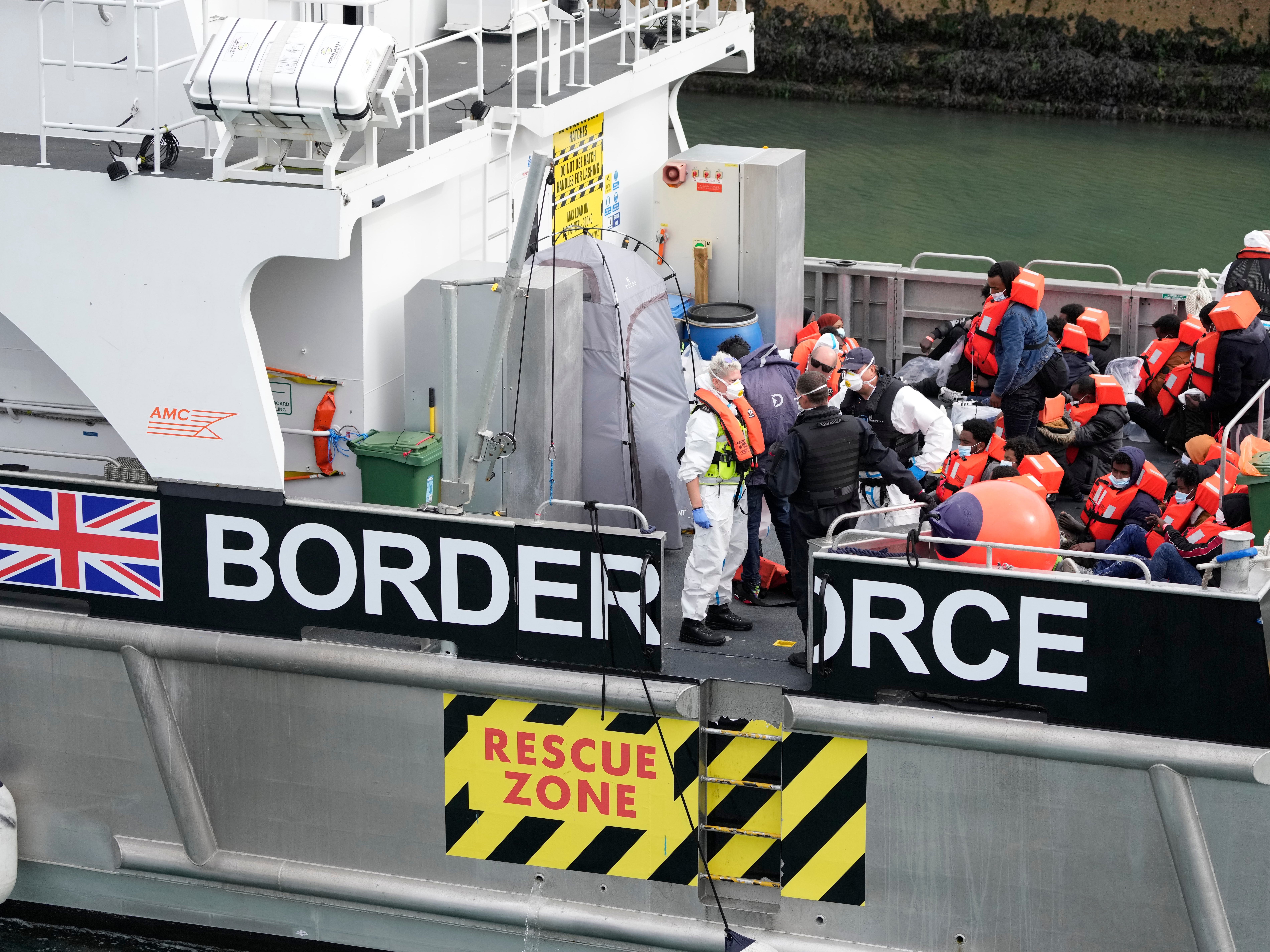 People thought to be migrants are brought into port after being picked up in the English Channel by a British border force vessel on 13 August