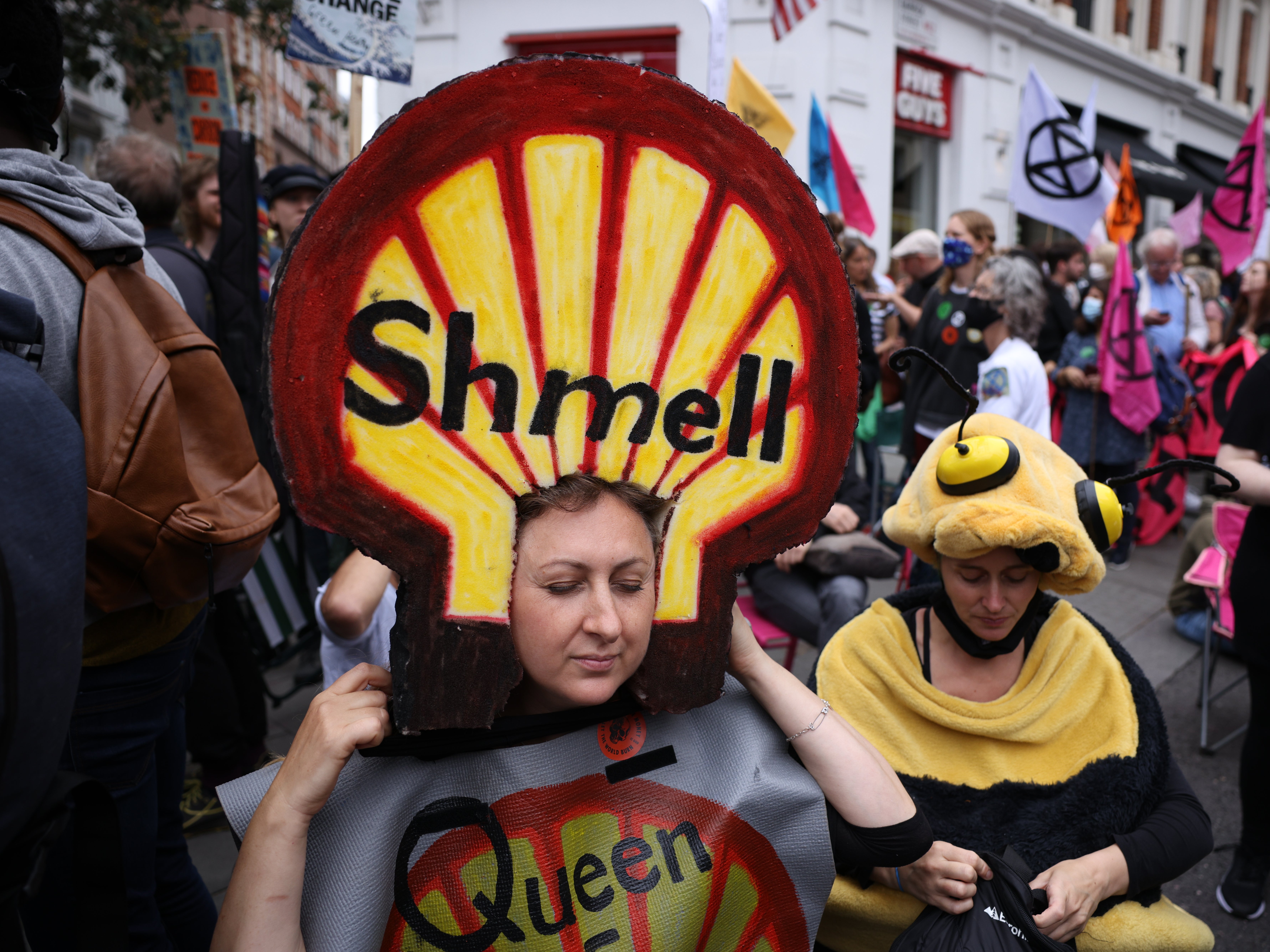 Protesters dressed in costumes gather beneath XR’s crisis-talks table