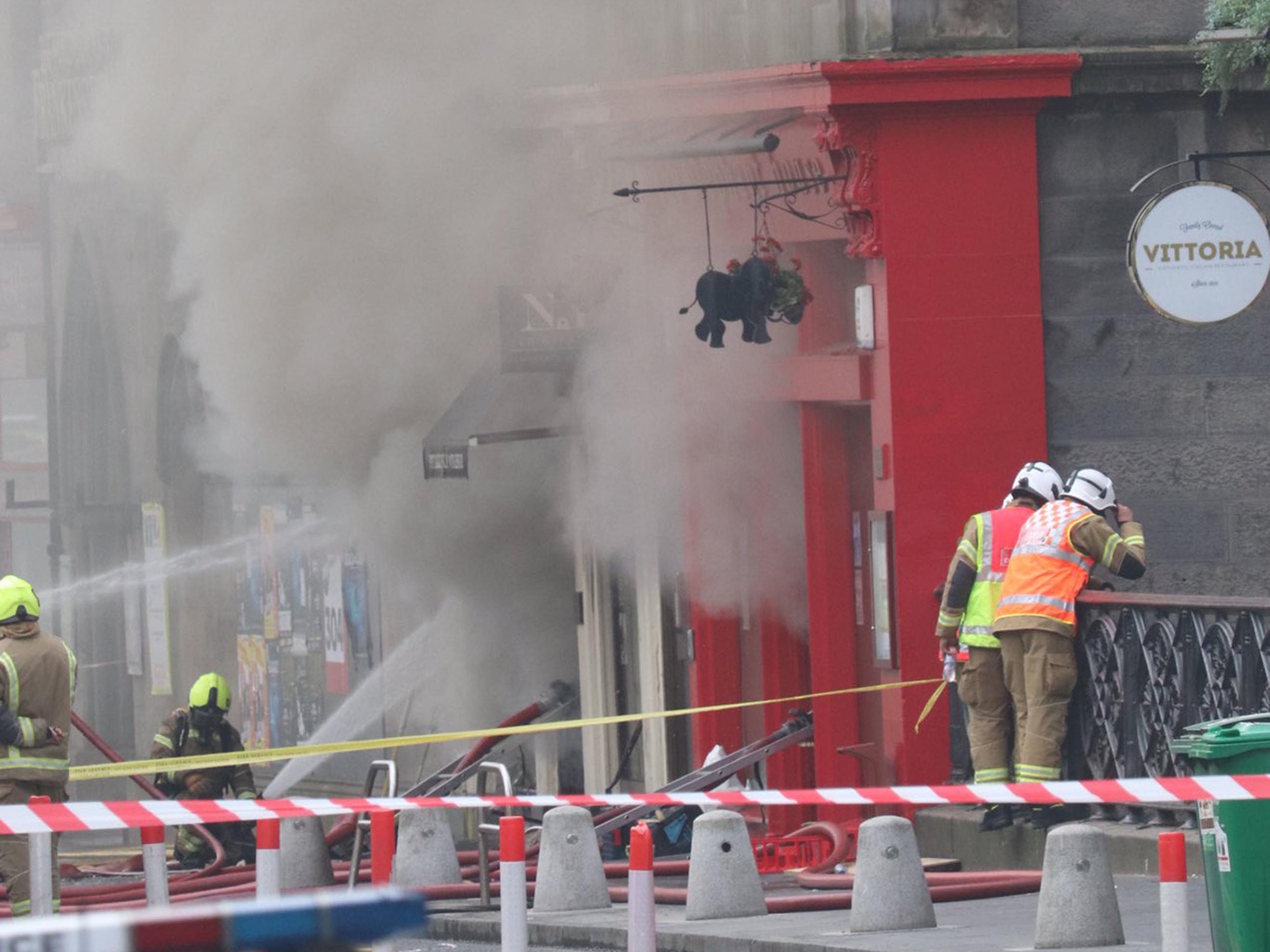 Firefighters at the scene of a large fire at George IV Bridge in Edinburgh which has closed several roads in the city centre