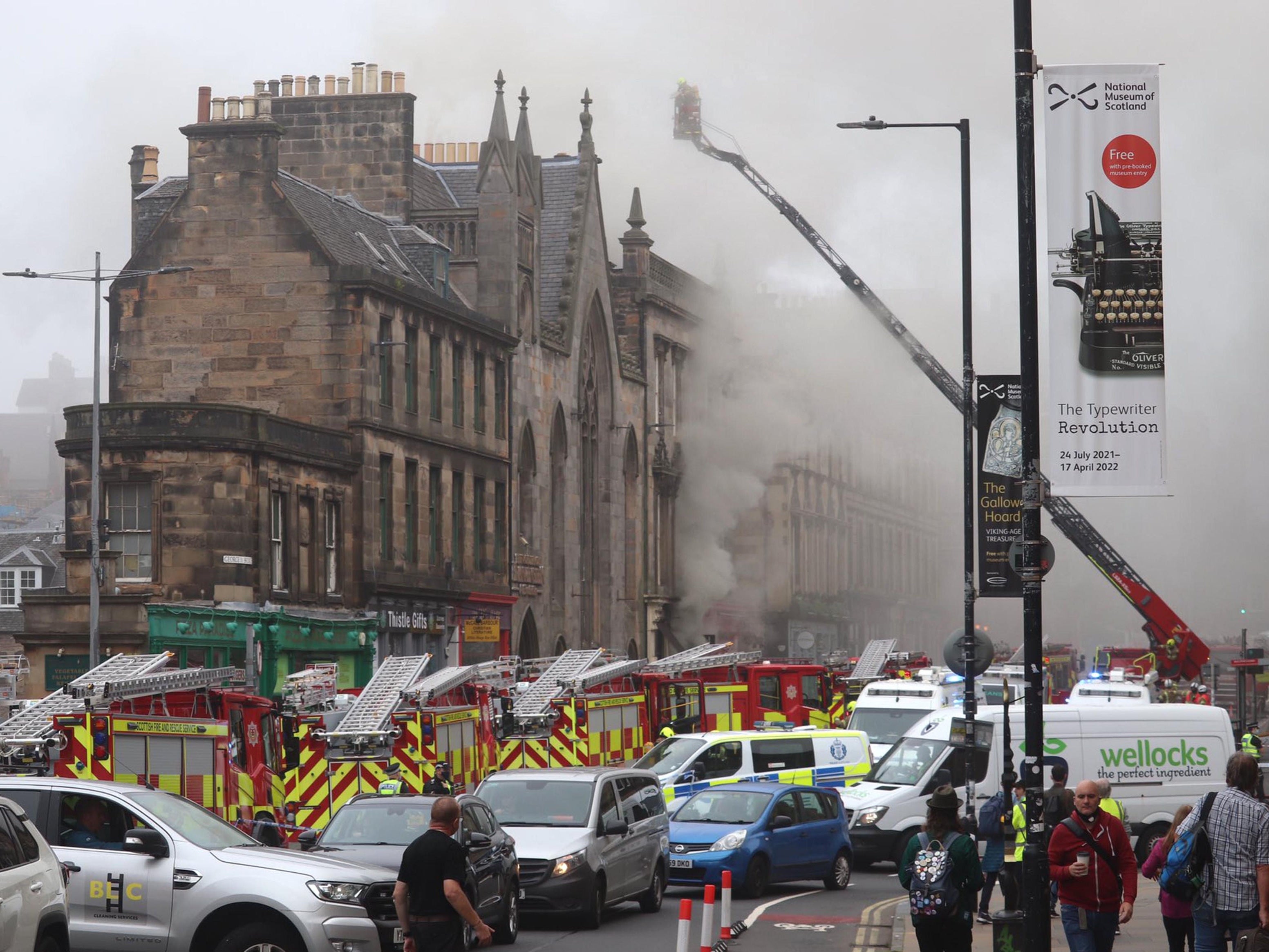 One person has been taken to hospital after a large fire closed the George IV Bridge in Edinburgh