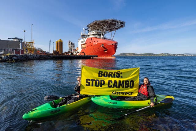 <p>Greenpeace activists confront a ship preparing kit for the Cambo oil field on Monday</p>