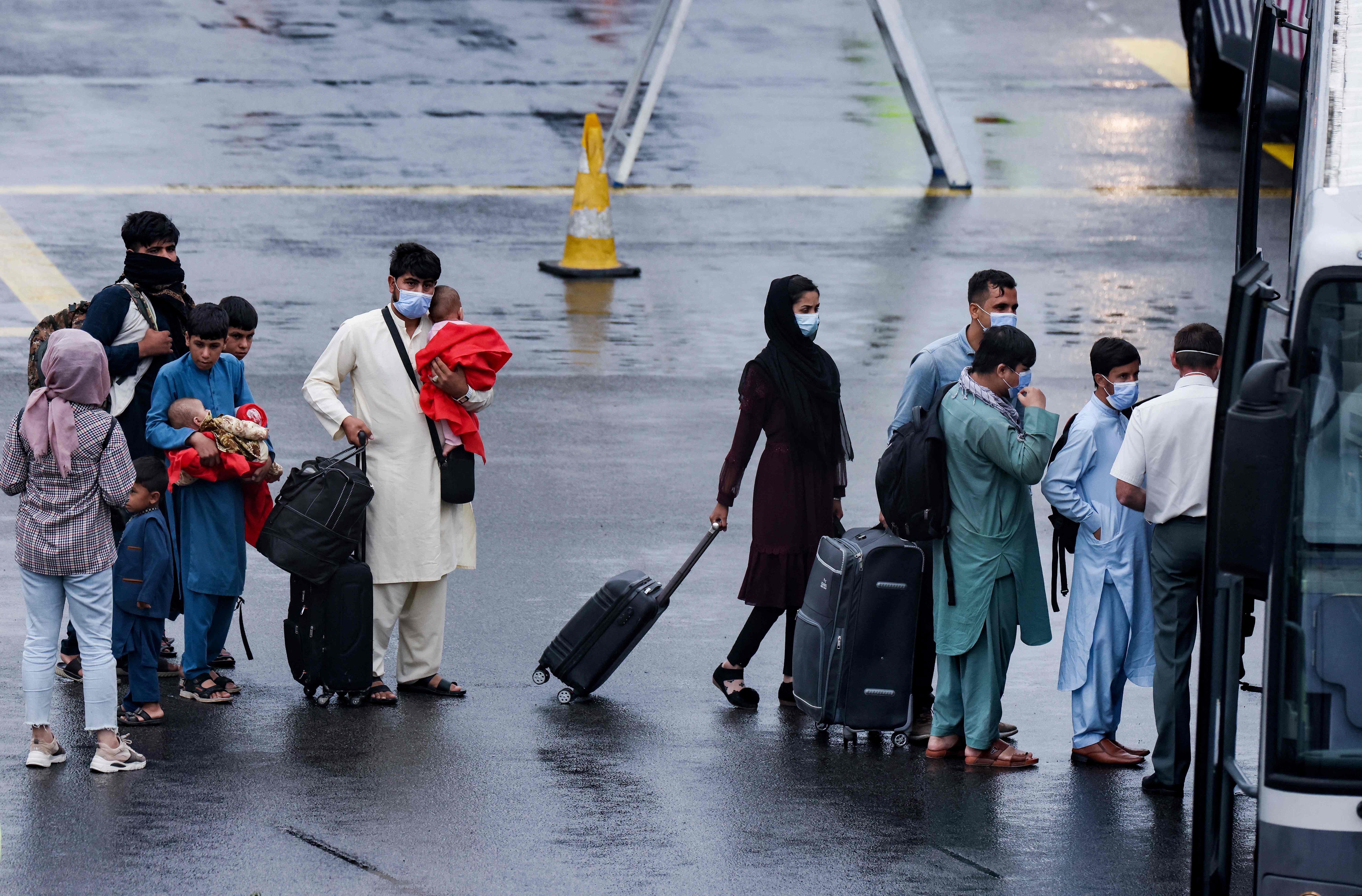 A group of Afghan nationals disembarking from a chartered Air Belgium airplane at the military airport in Melsbroek near Brussels