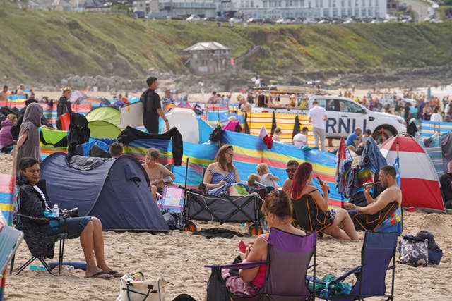 <p>Holidaymakers on the beach in Cornwall in summer 2021 </p>