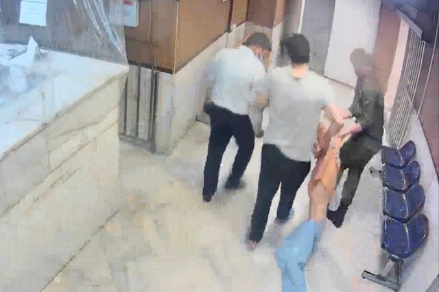 <p>Guards drag an emaciated prisoner at Evin prison in Tehran</p>