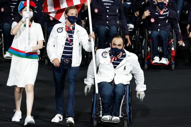 <p>Flag bearers Melissa Stockwell and Charles Aoki of Team United States lead their delegation in the parade of athletes during the opening ceremony of the Tokyo 2020 Paralympic Games at the Olympic Stadium on August 24, 2021 in Tokyo,</p>