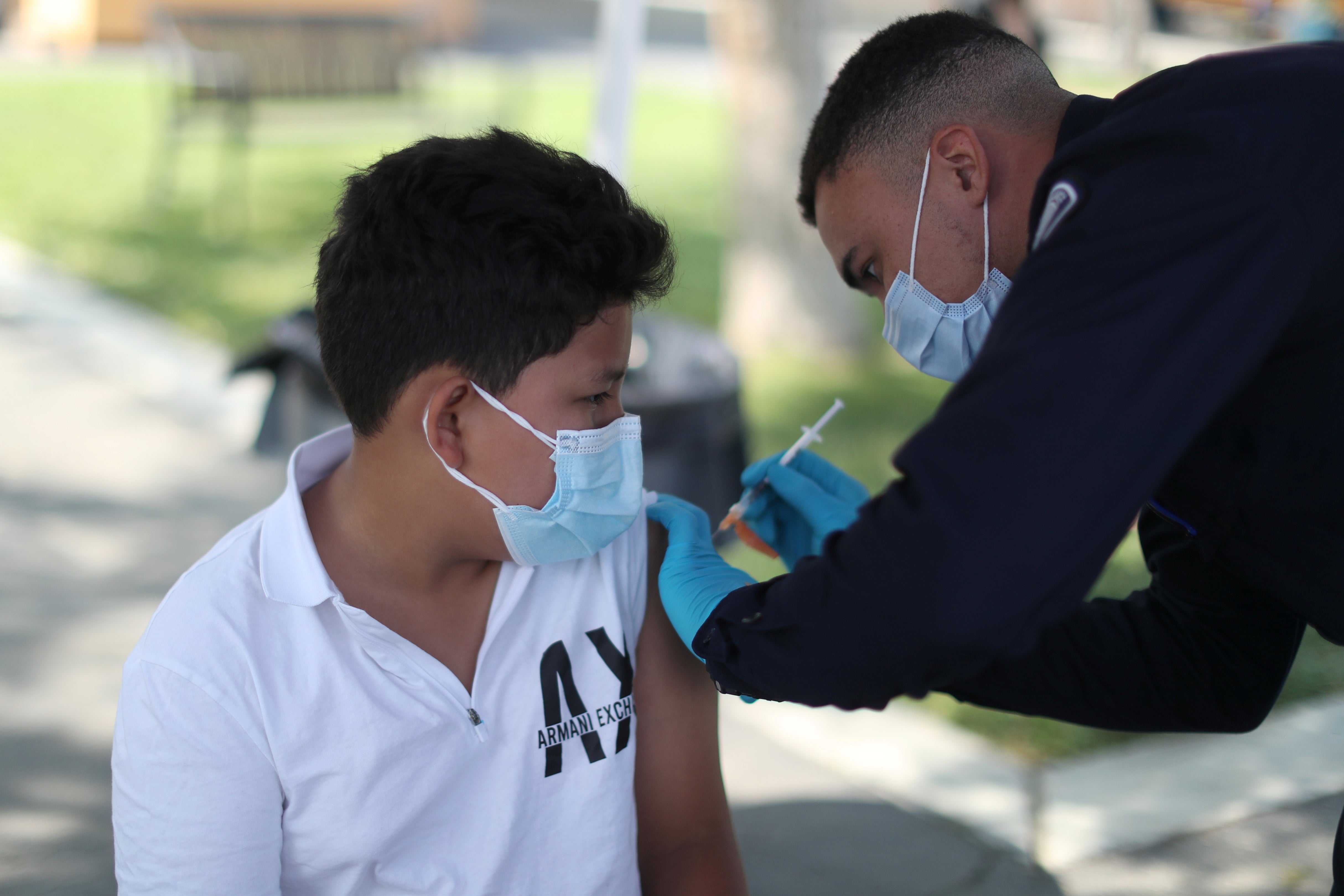A 12-year-old receives first dose of Covid-19 vaccine in Los Angeles