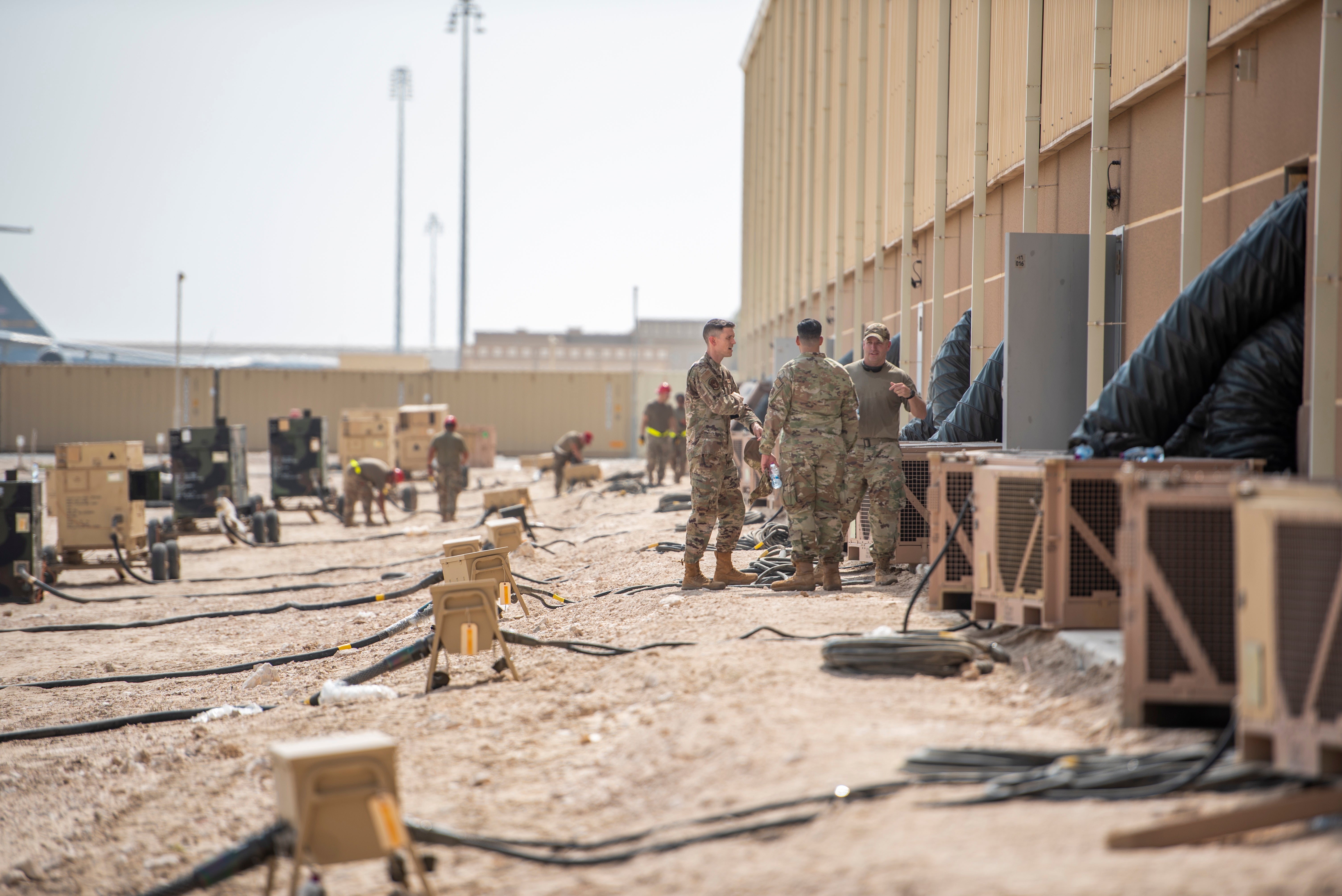 A handout photo made available by the US Central Command Public Affairs shows service members prepare a warehouse with generators and air condition for evacuees at Al Udeid Air Base, Qatar, 22 August 2021.