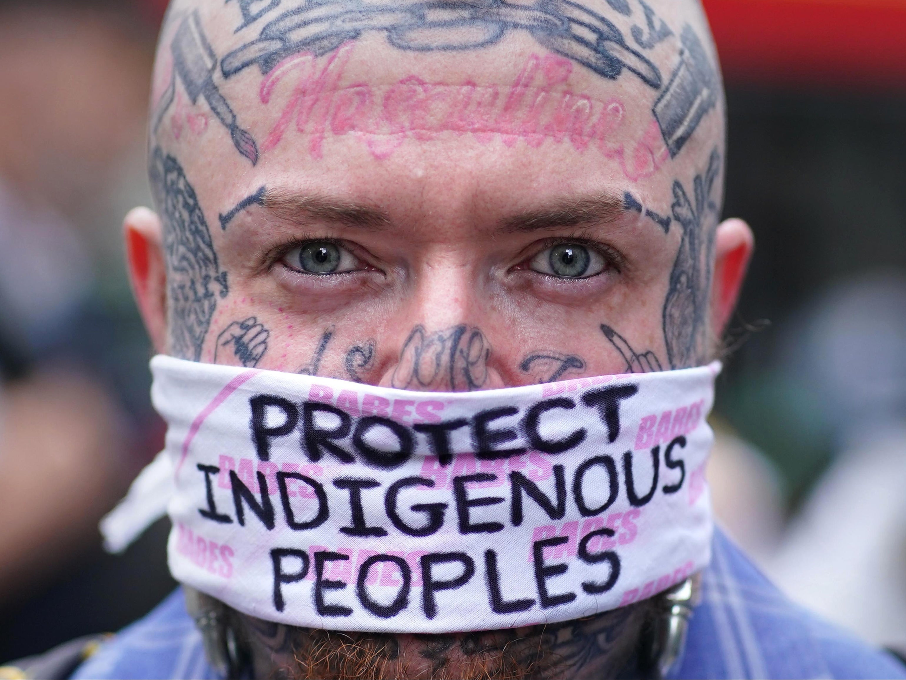 A demonstrator during a protest calling for an end to 'the genocidal attacks being waged against Brazil's indigenous peoples' at the Brazilian Embassy