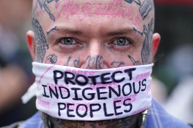 <p>A demonstrator during a protest calling for an end to 'the genocidal attacks being waged against Brazil's indigenous peoples' at the Brazilian Embassy</p>