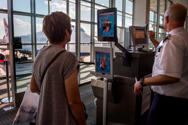 <p>A woman boarding a SAS flight to Copenhagen goes through facial recognition verification system VeriScan at Dulles International Airport in Dulles, Virginia</p>