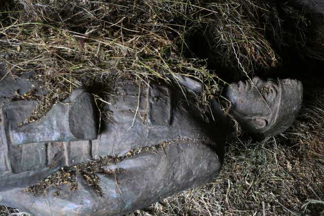 <p>The bronze effigy of the late communist dictator Enver Hoxha is hidden in the basement of an Albanian museum that was destroyed after 1991</p>