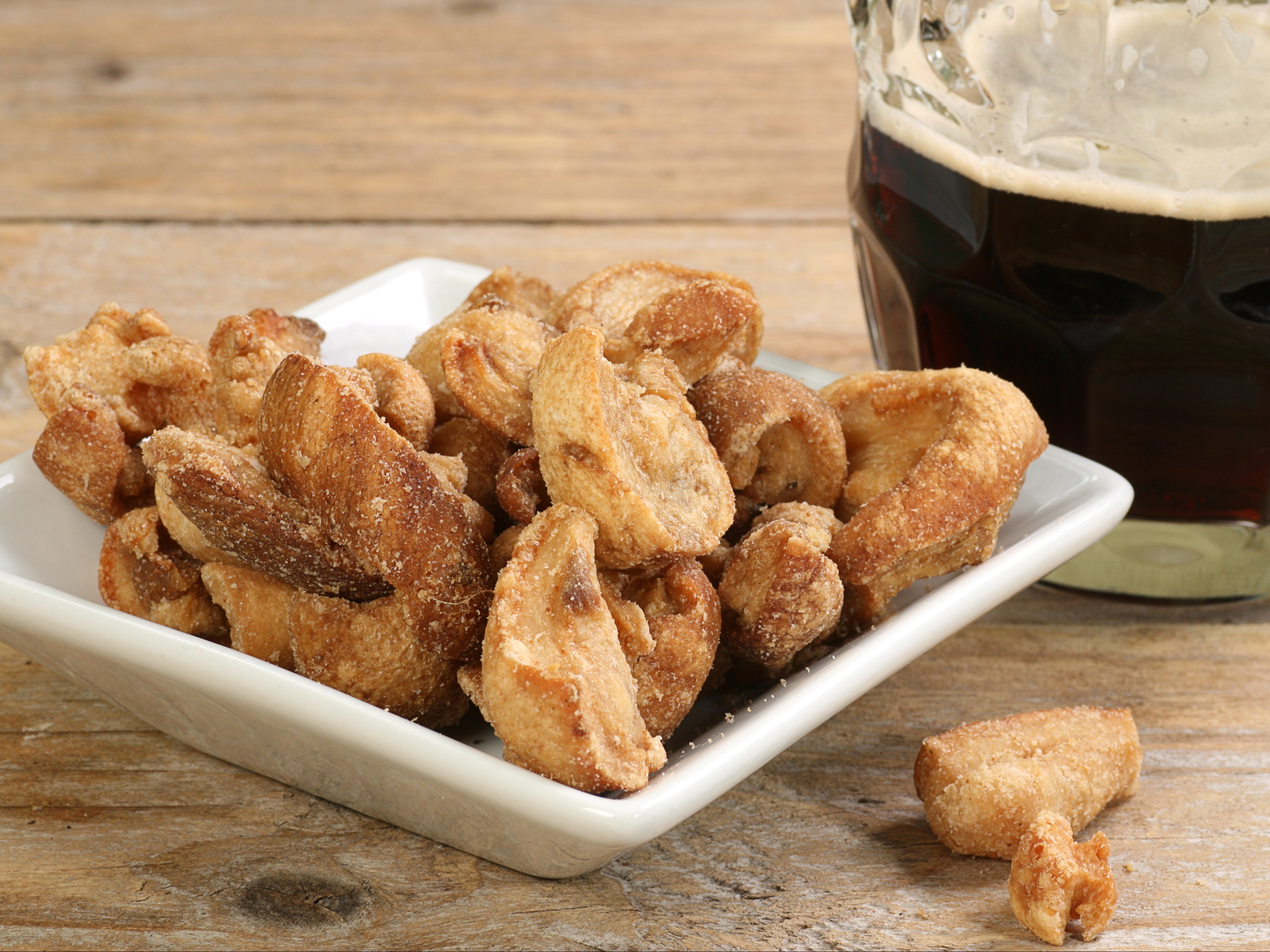 Batches of pork scratchings have been linked to scores of salmonella cases in the UK
