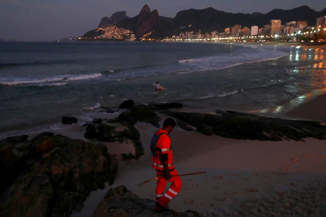 <p>Felipe on patrol along Arpoador beach in Rio picking litter </p>