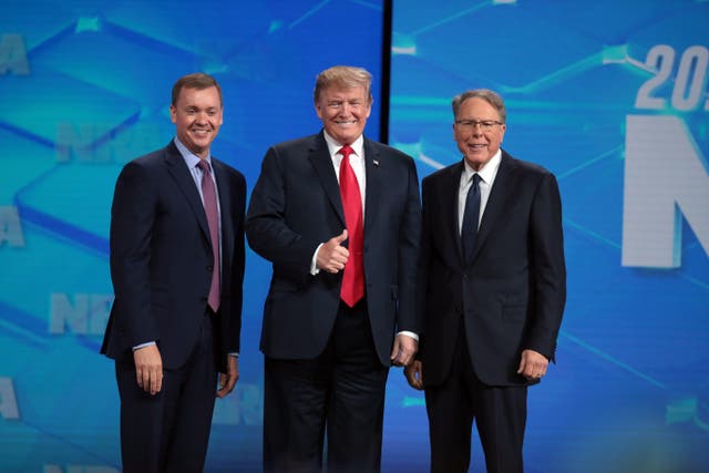 <p>U.S. President Donald Trump gives a thumbs up to the crowd as he stands on stage along with NRA Executive Vice President Wayne LaPierre (R), and Executive Director NRA-ILA Chris Cox (L) at the NRA-ILA Leadership Forum at the 148th NRA Annual Meetings & Exhibits on April 26, 2019 in Indianapolis, Indiana. </p>
