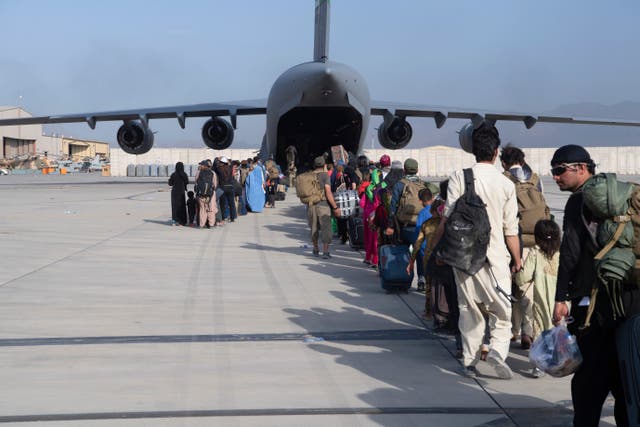 <p>Evacuees queue to board  a US air force plane at Hamid Karzai International Airport in Kabul on Tuesday</p>
