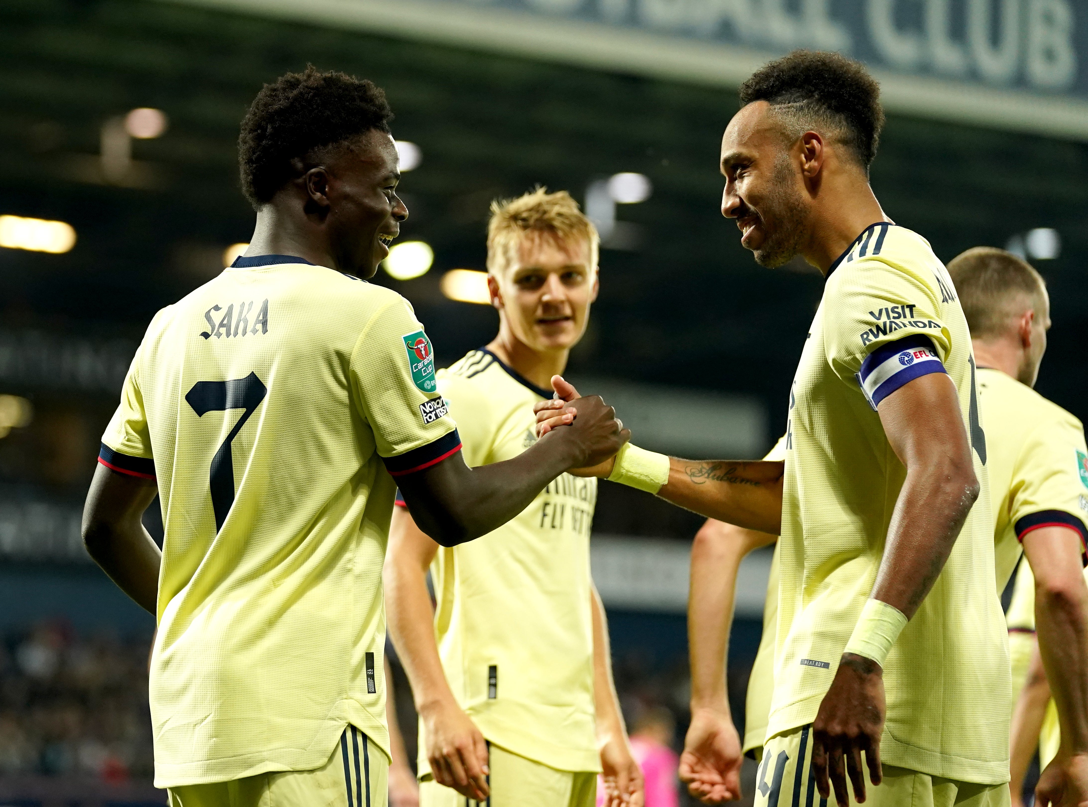 Bukayo Saka (left) and Pierre-Emerick Aubameyang (right) celebrate during a thumping win at West Brom (Nick Potts/PA)