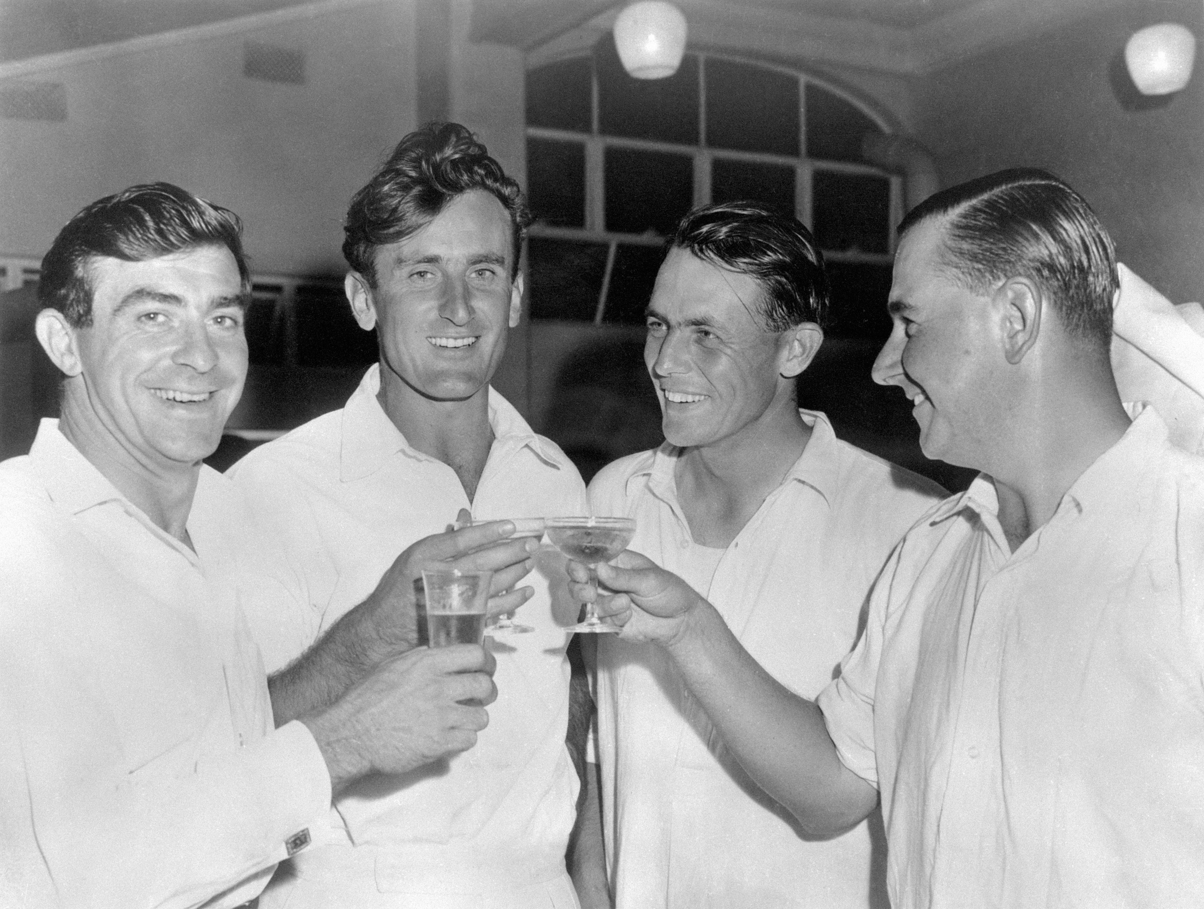 Ted Dexter, second left, celebrates an England victory with Fred Trueman, David Sheppard, and Colin Cowdrey (PA)