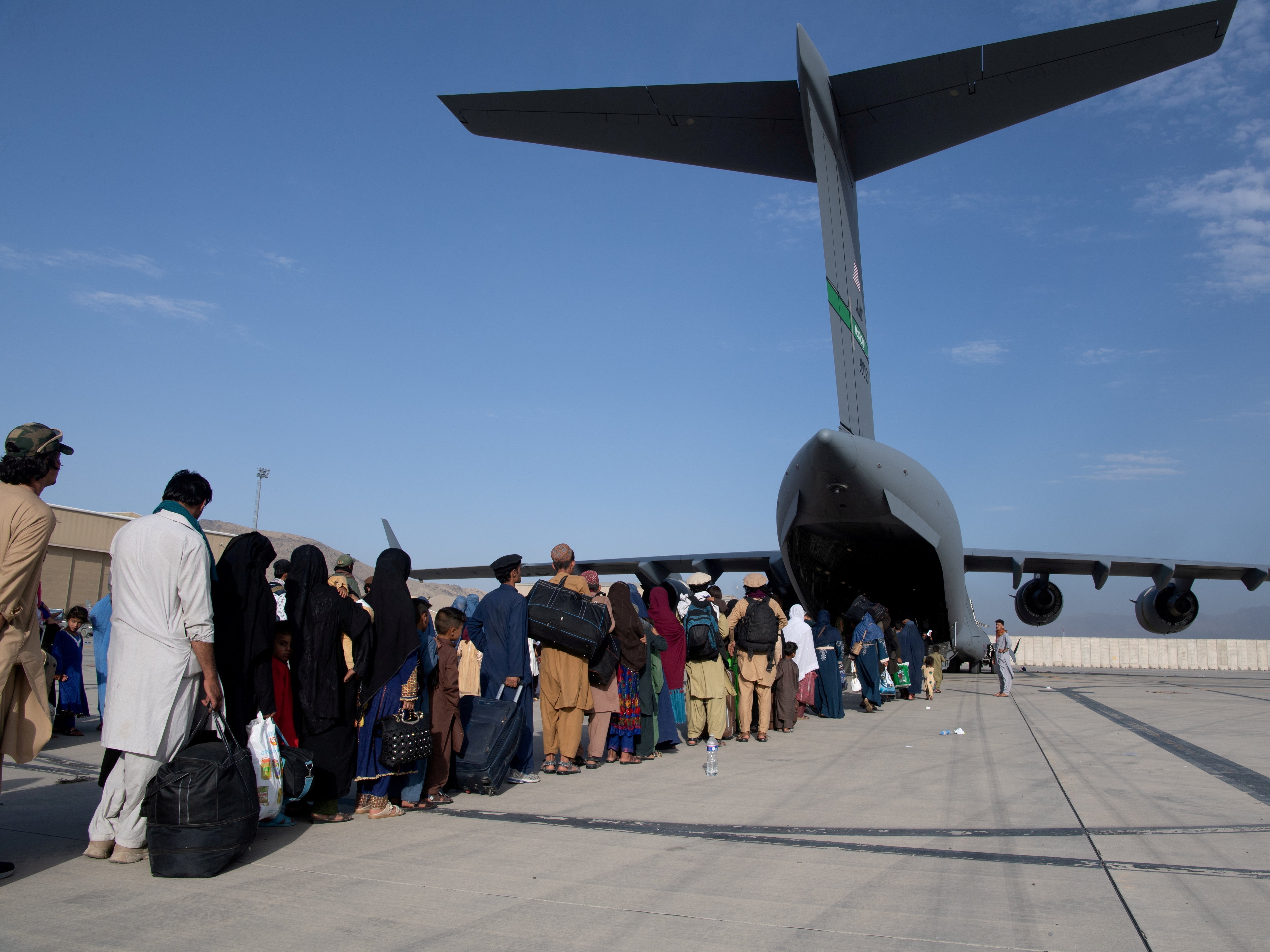 The US Air Force load passengers onto a C-17 Globemaster III at Hamid Karzai International Airport in Kabul, Afghanistan on August 24, 2021