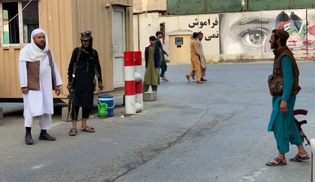 <p> Taliban members at the entrande to the Green Zone in Kabul where most Western embassies are situated</p>