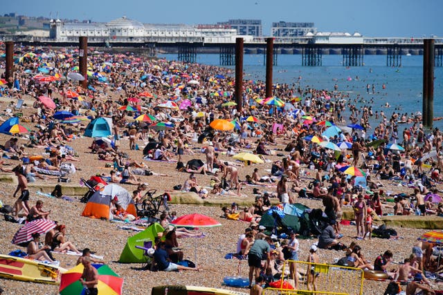 <p>People enjoying the hot weather on Brighton beach in July 2021</p>