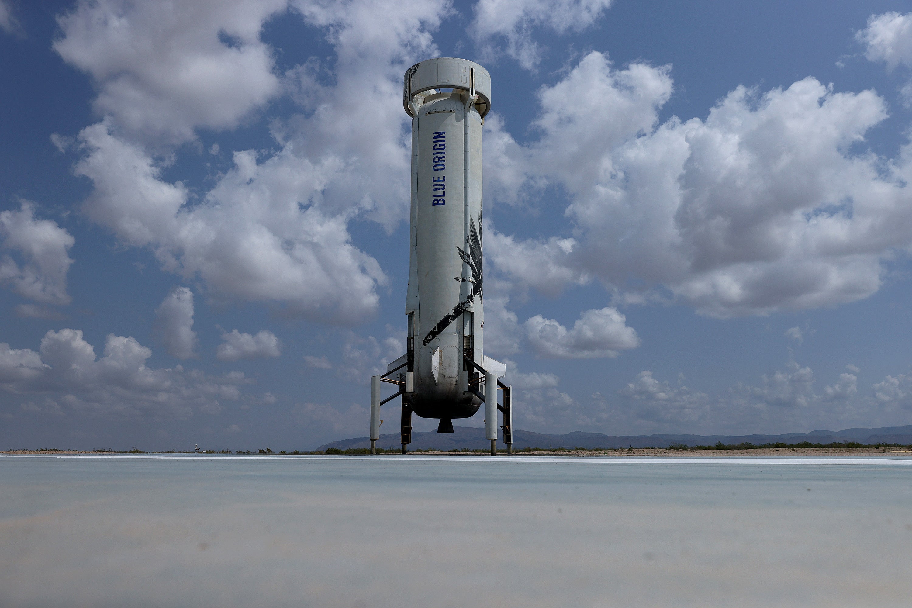 The booster for Blue Origin’s New Shepard sits on the landing pad after powering the rocket into space on July 20, 2021 in Van Horn, Texas