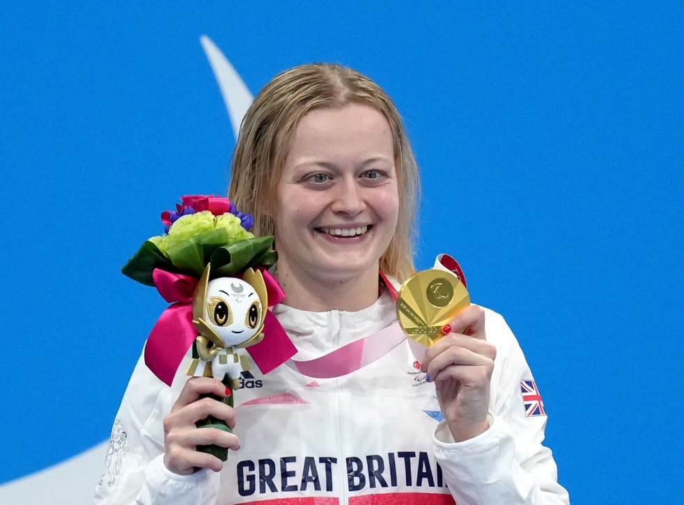 <p>Hannah Russell celebrates after retaining her S12 100m backstroke title</p>